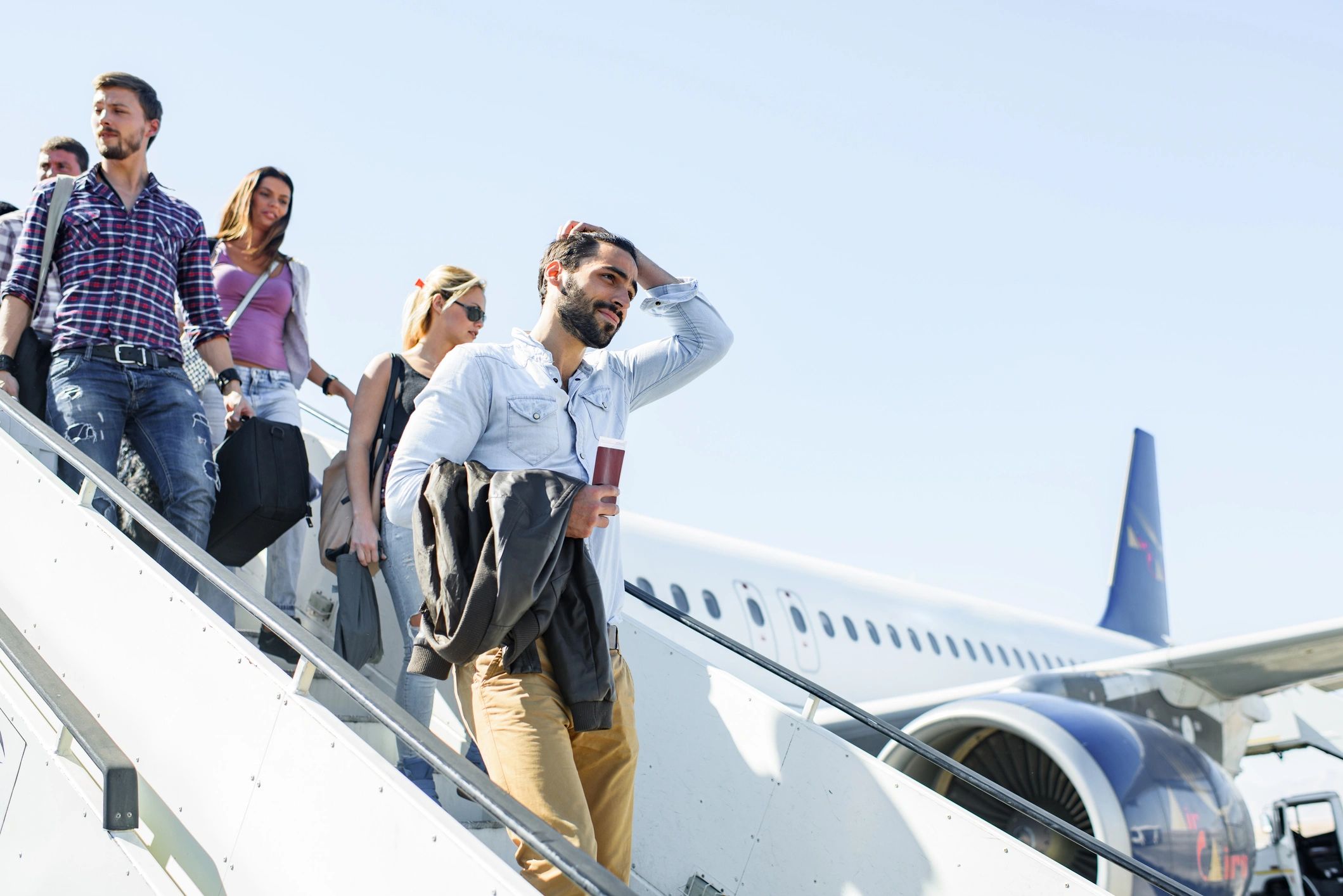 Passengers disembarking via aircraft stairs