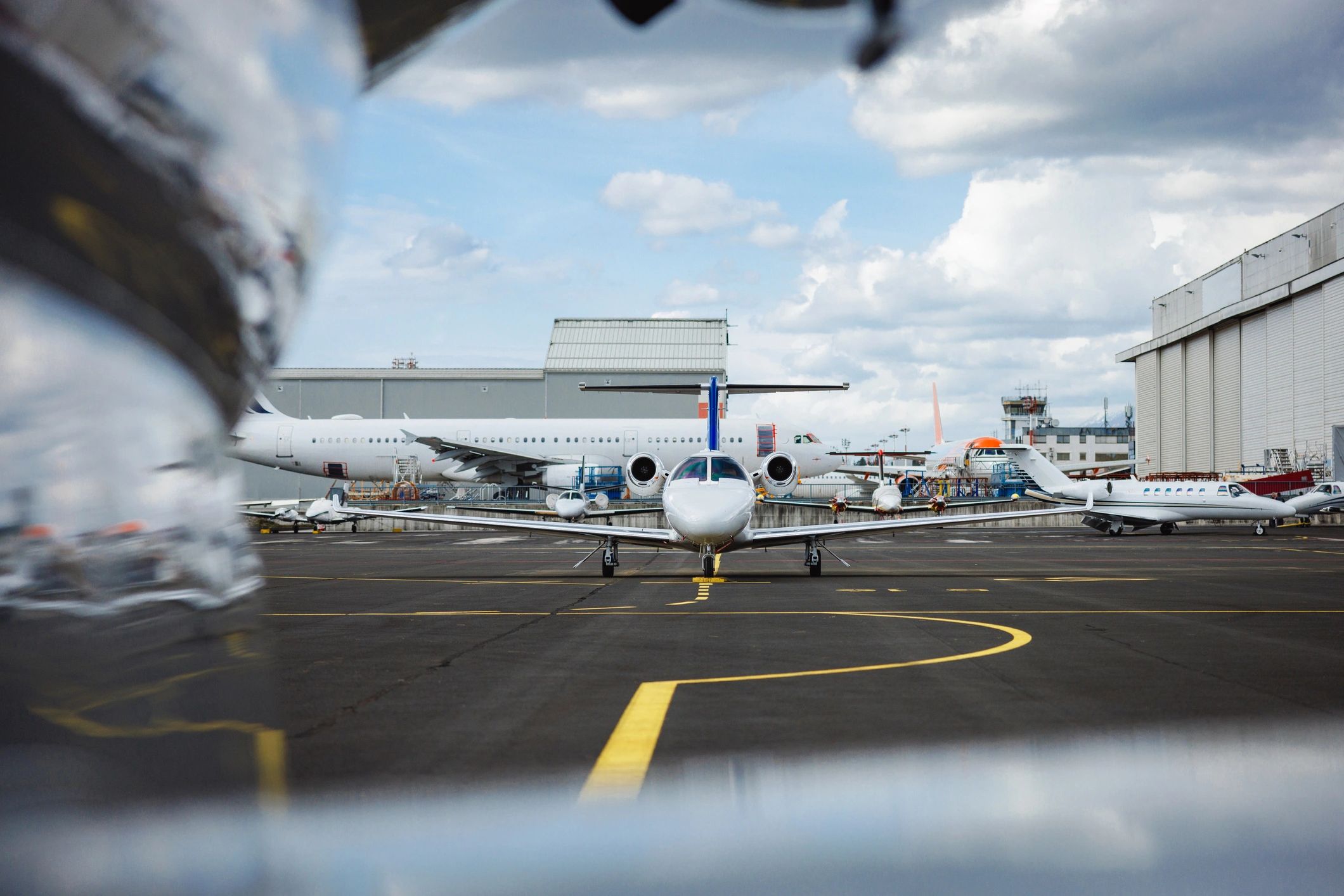 Private jets parked on an airport apron